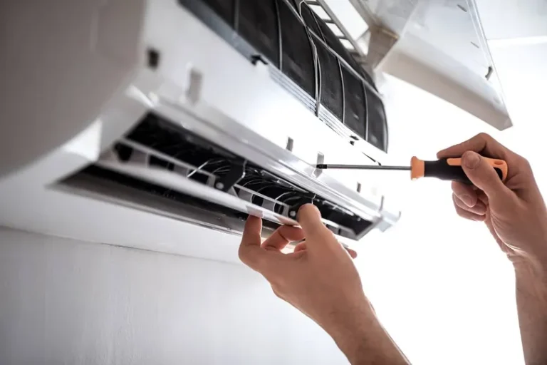 A worker fixing an AC unit