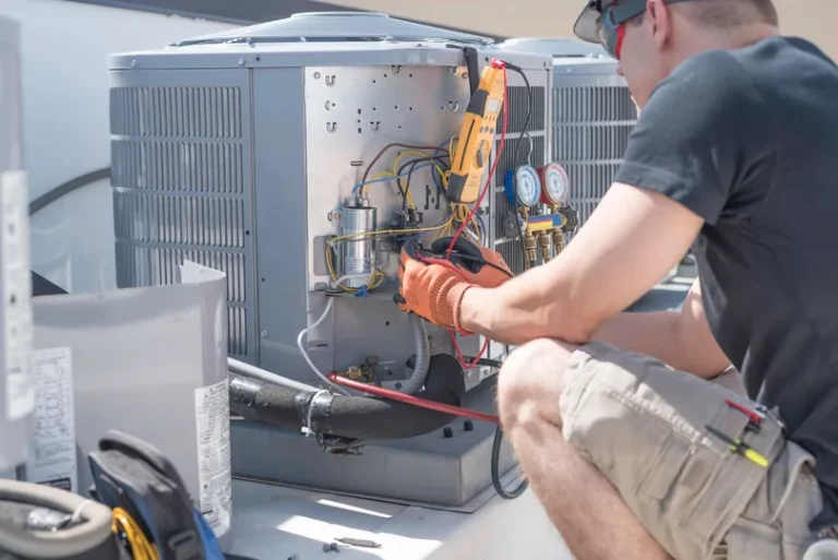 A worker repairing an AC unit in Leesburg