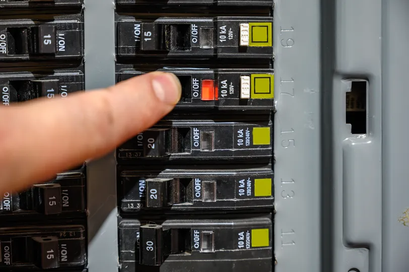 finger pointing at breaker box