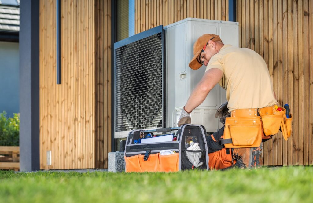 hvac worker installing modern heat pump