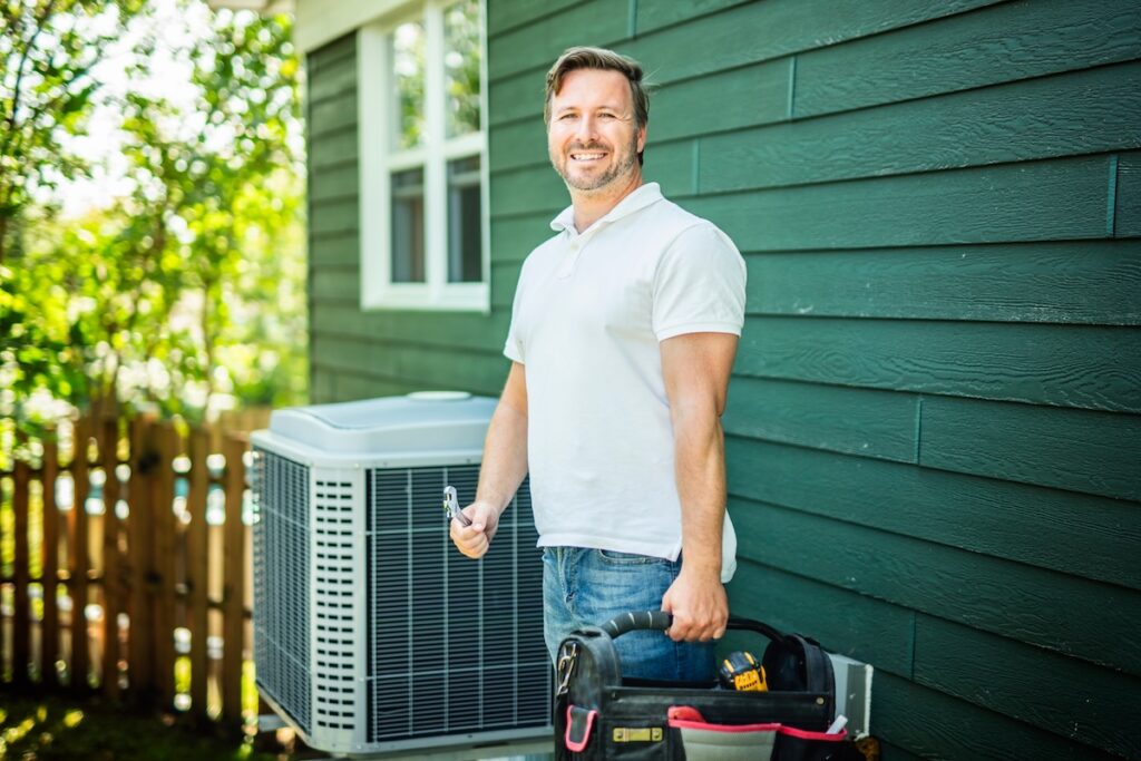 technician installing heat pump