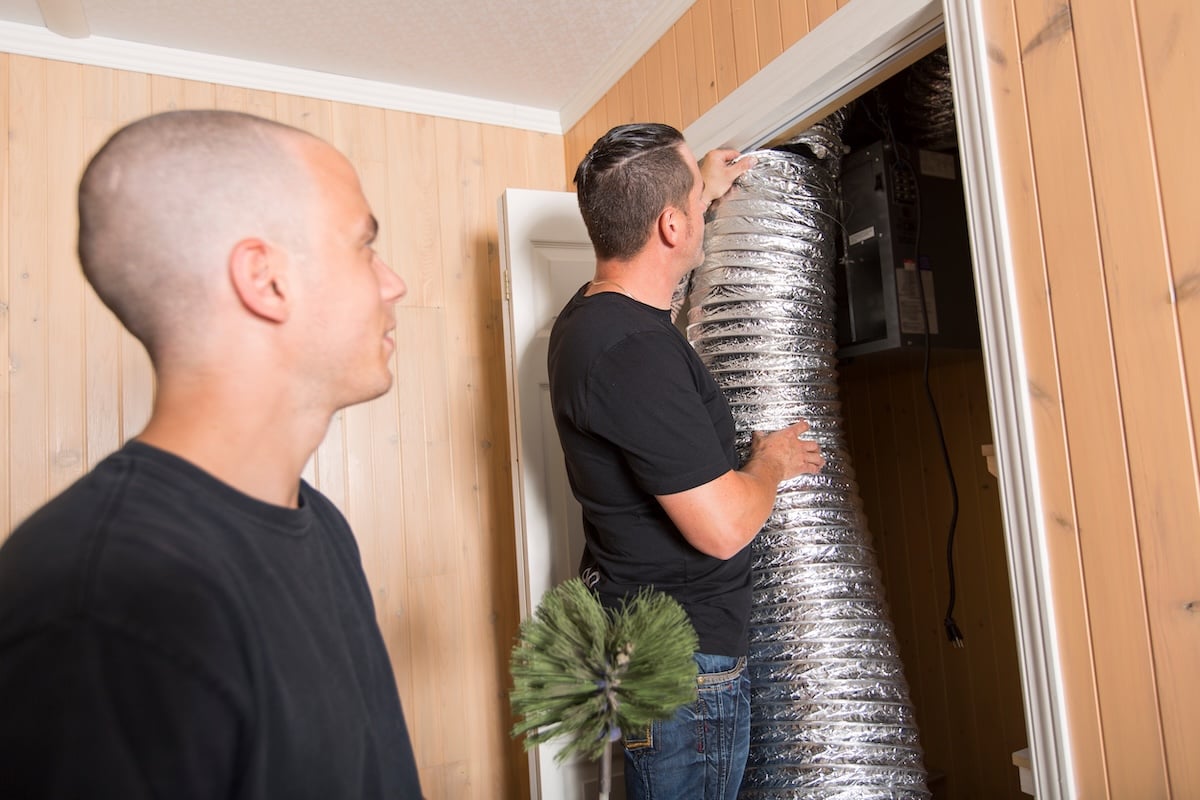 A ventilation cleaner man at work with tool