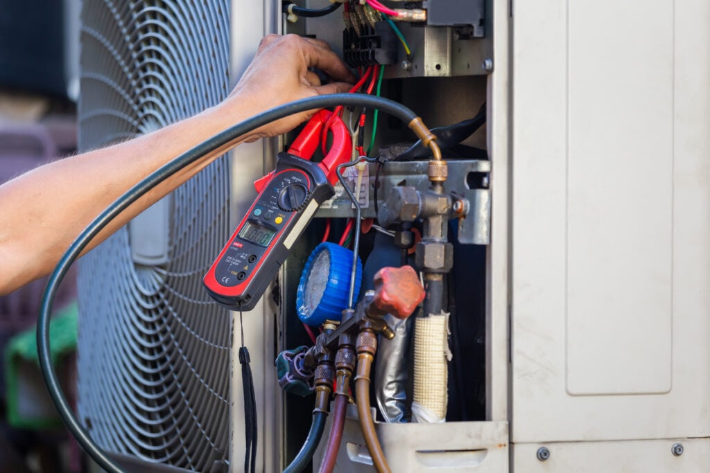 Air Conditioning Repair man hands checking and fixing modern air conditioning system, Technician team checking leakage air conditioning system ac tune up