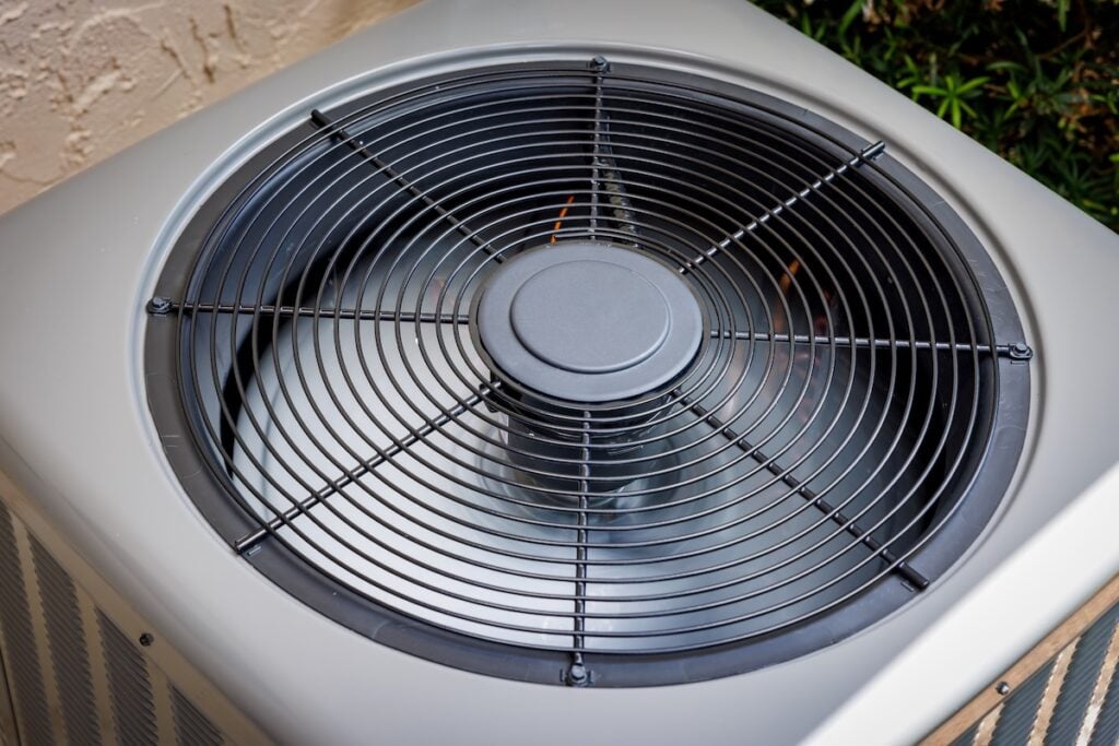 Modern residential HVAC air conditioner unit fan top view.