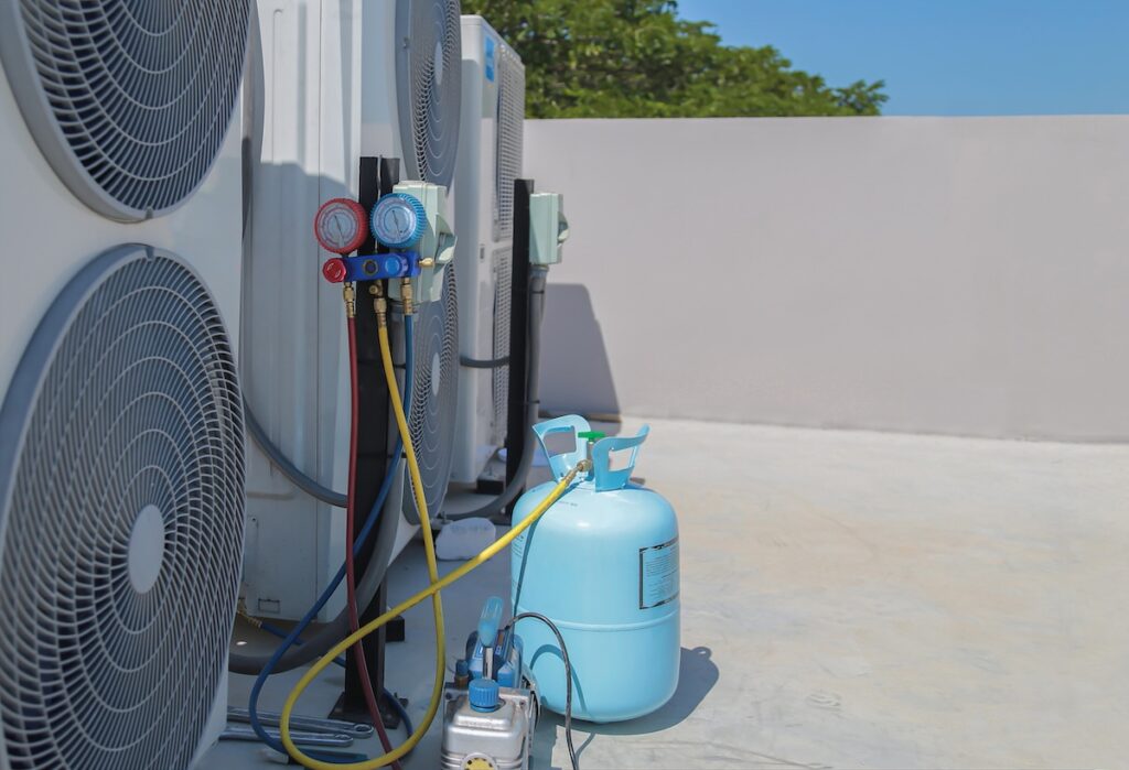 ac refrigerant ac refrigerant HVAC technician checking air conditioner operation.