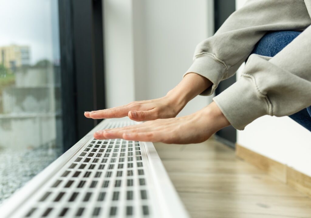 hands on radiator in the winter