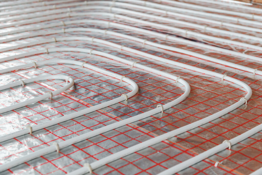 Underfloor heating installation. Close up on water floor heating system interior. plumbing pipes. Individual Heating.