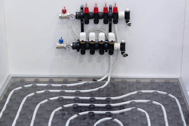 Underfloor heating system and collector at the exhibition stand. Industry