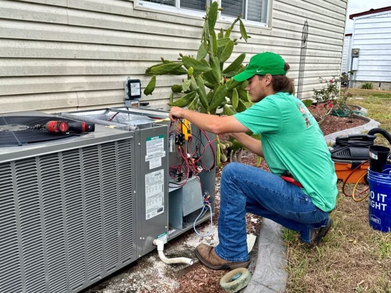 Bob's AC worker fixing air conditioner outside unit