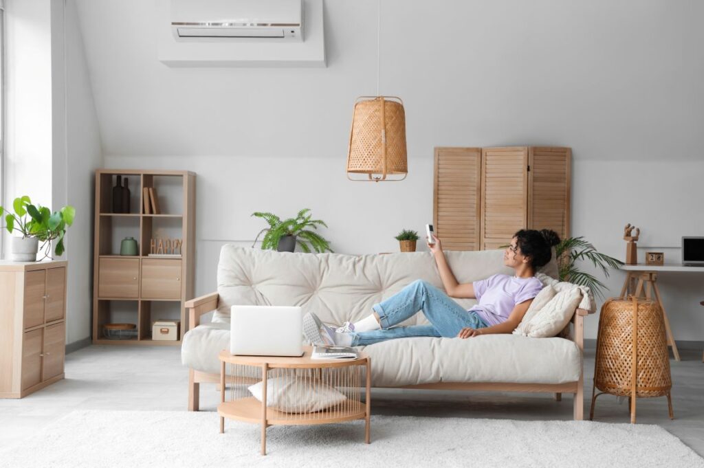dirty air filter symptoms woman enjoying AC laying on a couch