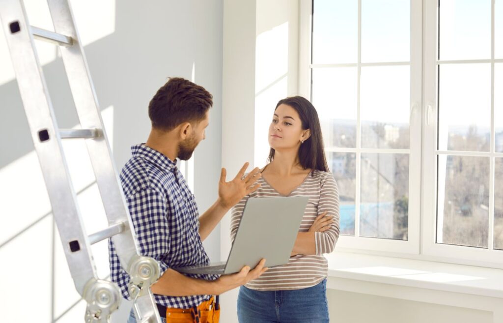 ac installation lady lake fl worker speaking with client showind computer inside house
