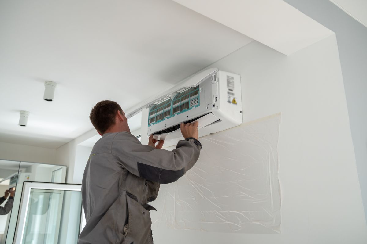 ac installation wildwood fl worker installing white unit