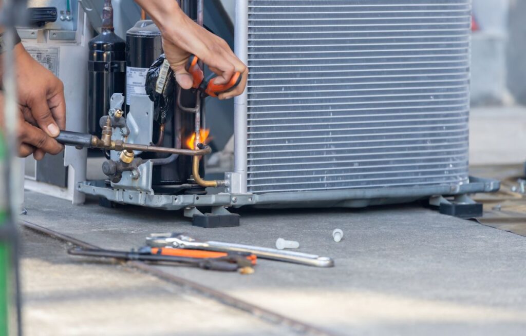 ac installation wildwood fl worker repairing outside unit