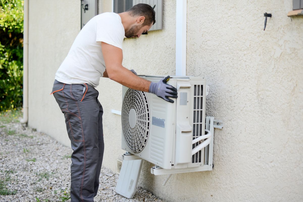 ac repair wildwood fl worker installing new unit