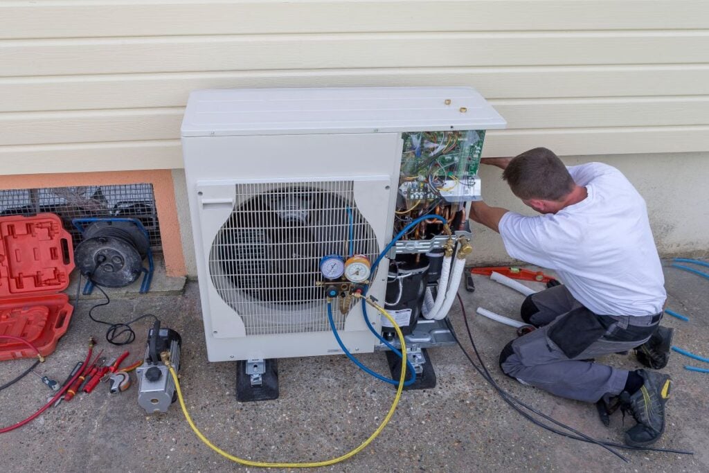 heat pump installation wildwood fl worker repairing unit outside