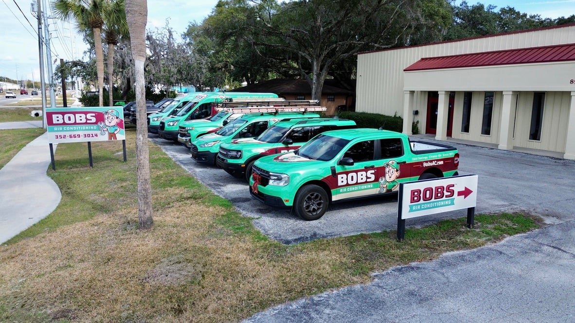 Fleet of green service trucks parked.